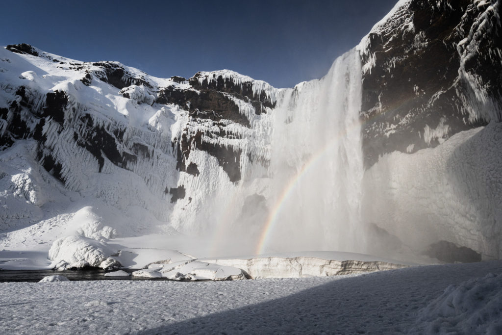Frozen Skógafoss contrasting landcapes iceland jeroenvannieuwenhove