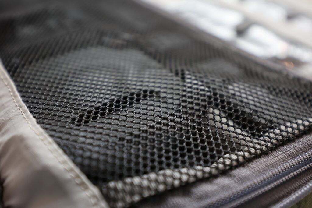The mesh cover keeps your stuff from falling out when it opens