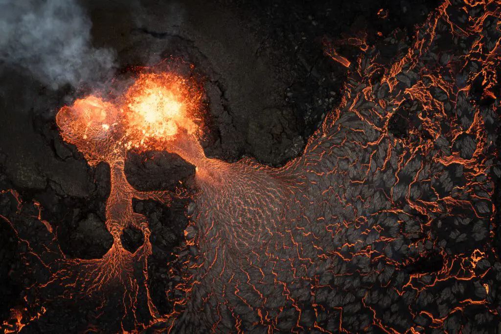 Top-down aerial of a lava fountain with spider-leg lava streams branching out, Fagradalsfjall.