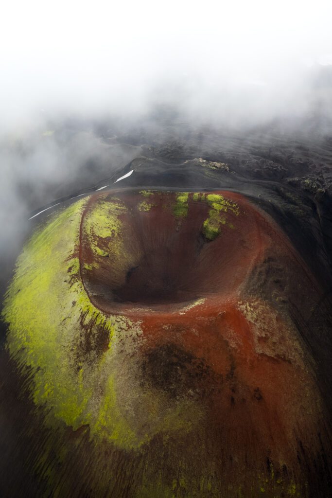 Aerial drone view of a moss-covered volcanic crater in the Icelandic Highlands.