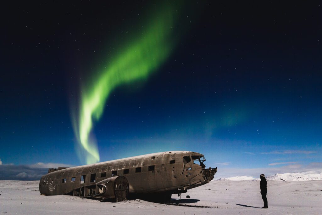 Aurora curtain twisting above the Sólheimasandur DC-3 plane wreck on the south coast.