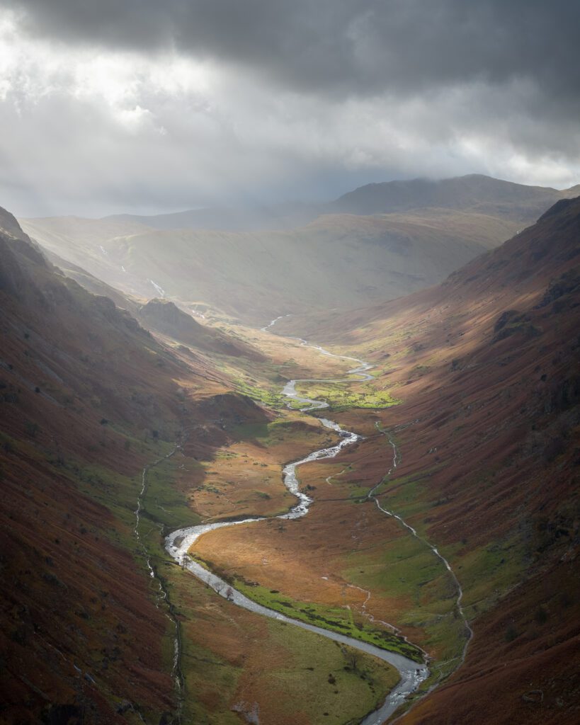 United Kingdom Sun beams hitting a valley in the Lake District in England