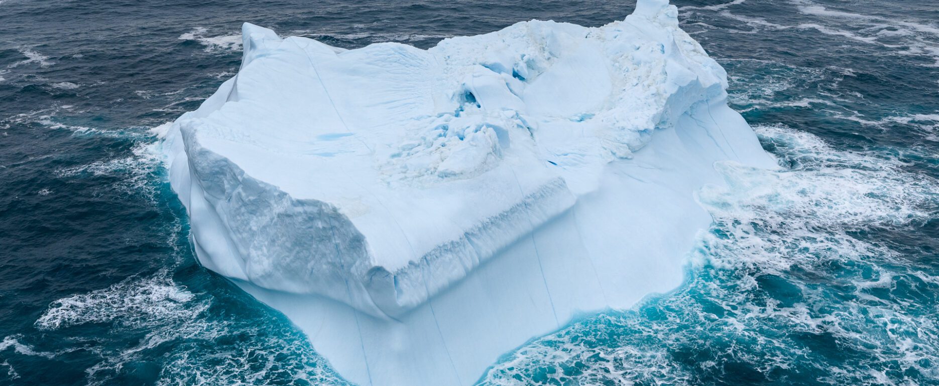 Stormy waters around a free-floating iceberg in Greenland