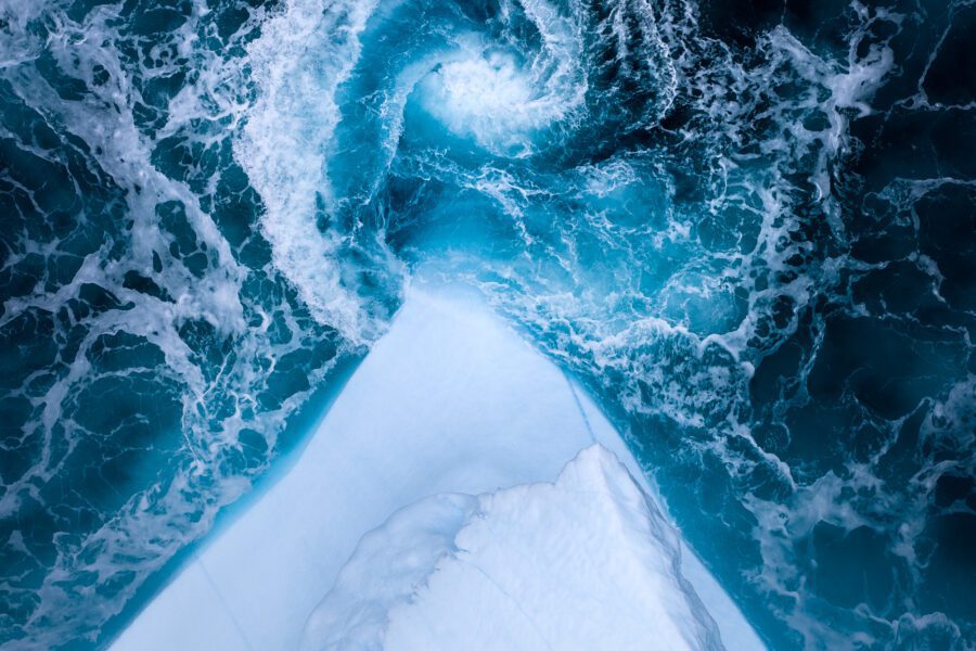 A whirlpool next to an iceberg in Greenland