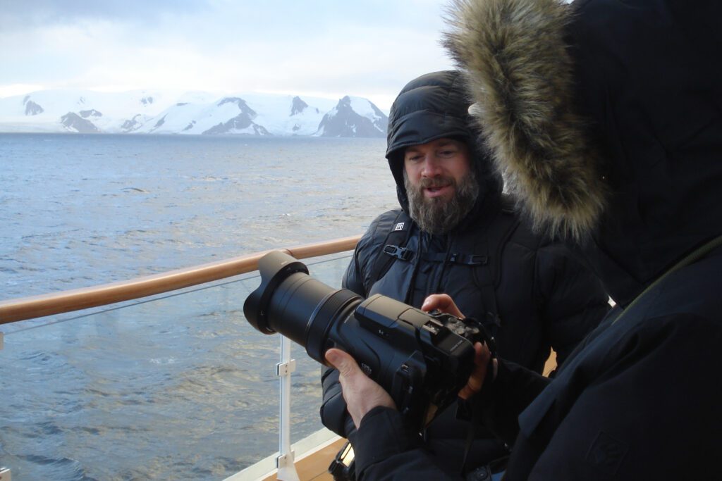 Photo Workshop Report: Antarctica & the Antarctic Peninsula 2026 Jeroen Van Nieuwenhove helping out photo workshop guests and participants