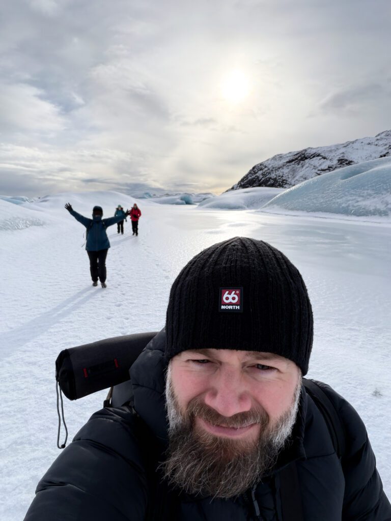 Selfie of Jeroen Van Nieuwenhove leading a winter workshop on a frozen glacial lagoon in Iceland.