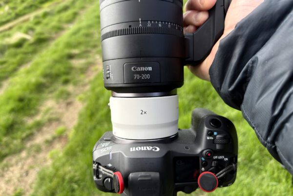 Top-down view of the RF 70-200mm F2.8 Z with the RF 2x extender on a Canon EOS R5, held over grass